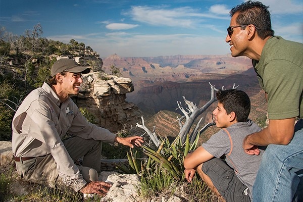 Tour guide with man and child.