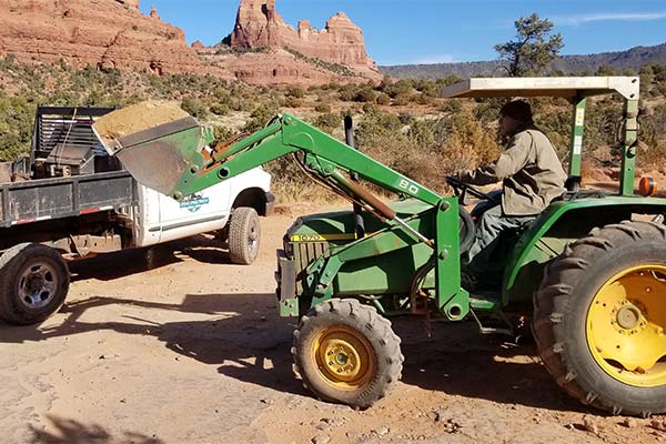 Rich Bowen, Pink Jeep Trail Maintenance worker on backhoe clearing Diamondback Gultch Trail.